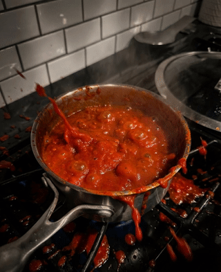 Red sauce splattering violently and making a big mess.